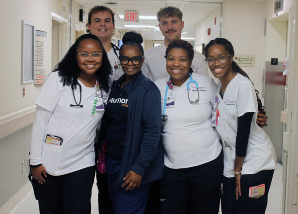 Troya Thomas (in blue scrubs), an RN at Piedmont Macon, is the clinical instructor for MGA nursing students rotating through clinical settings at the hospital. Piedmont funds her position through a special partnership with the University. She is shown with some of the MGA nursing students she has instructed.